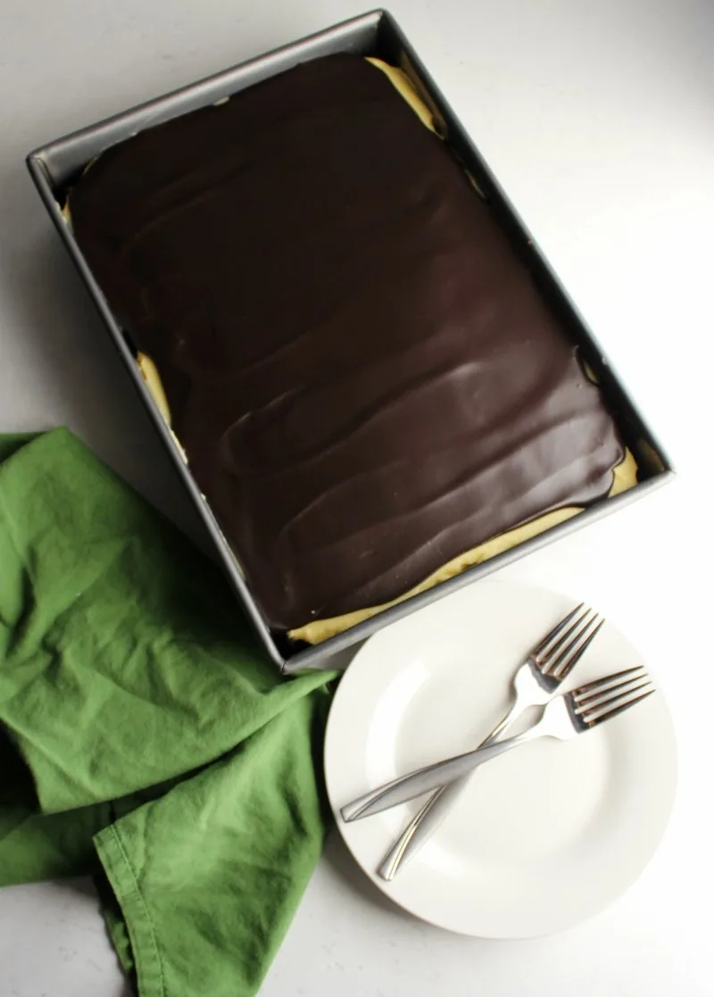 Whole sheet cake topped with shiny chocolate ganache, ready to be served.