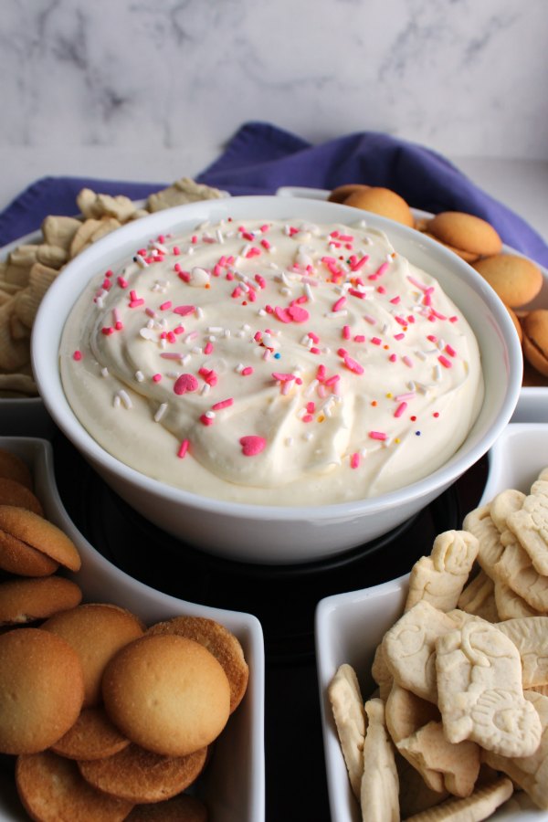 bowl of lemon cheesecake dip with animal cracker and vanilla wafer dippers