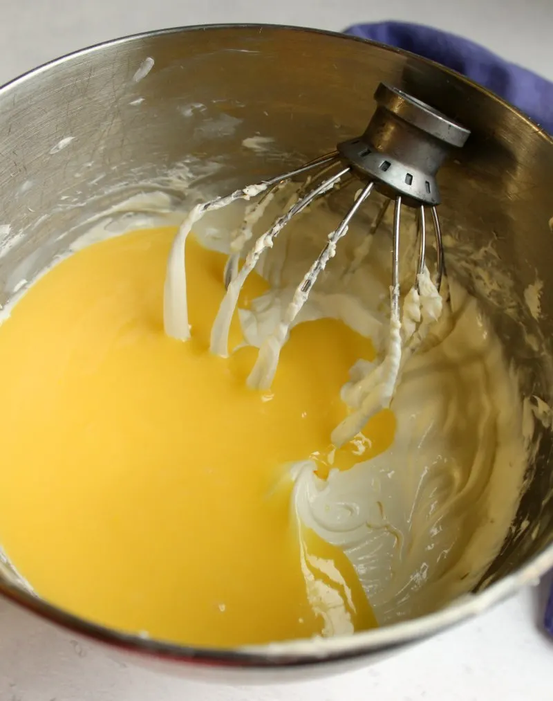 mixer bowl of no bake cheesecake with lemon curd.