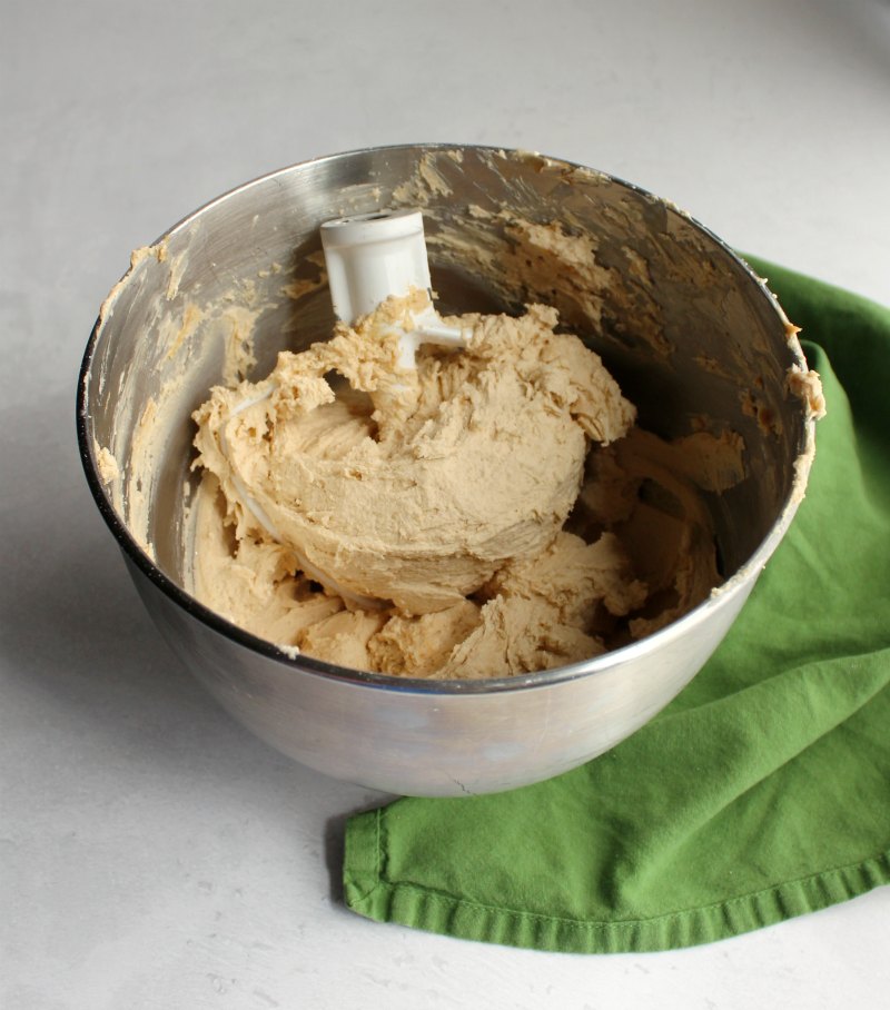 mixer bowl full of peanut butter and brown sugar buttercream frosting.