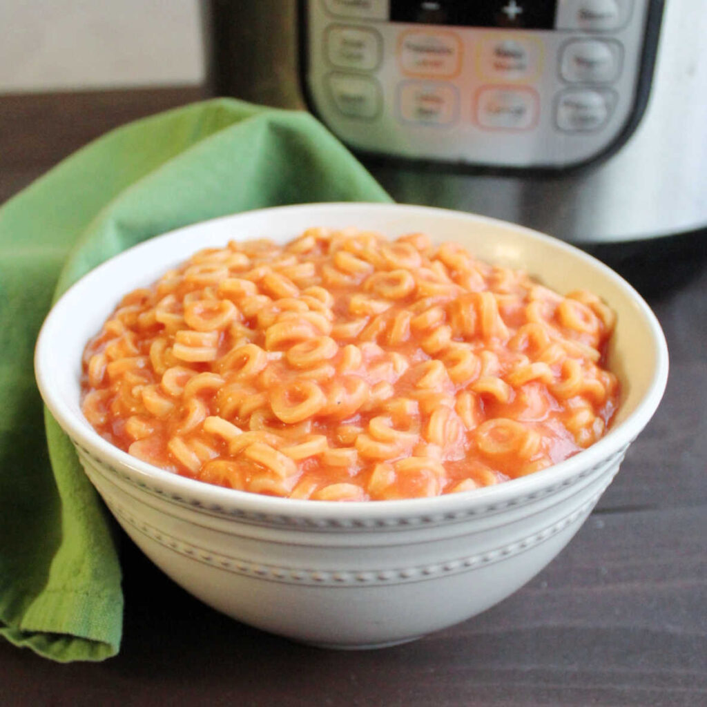 bowl filled with homemade spaghettios in front of instant pot.