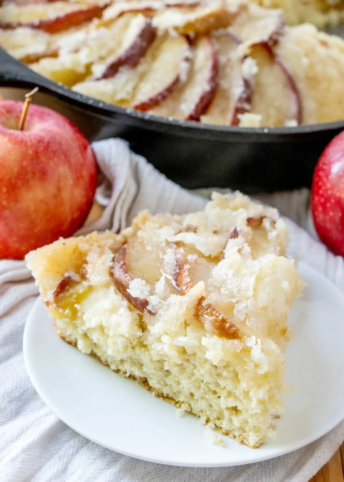 Slice of dutch apple cake with fresh apple slices and streusel on top, ready to eat. 