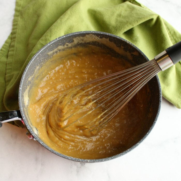 lumpy brown sugar custard mixture in saucepan for german buttercream