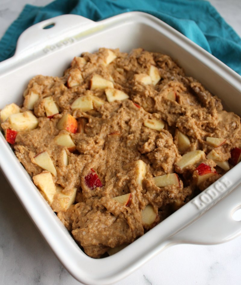 thick rustic buttermilk apple cake batter in square baking dish.
