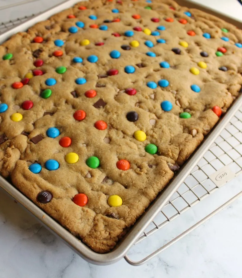 sheet pan full of blondies dotted with candies
