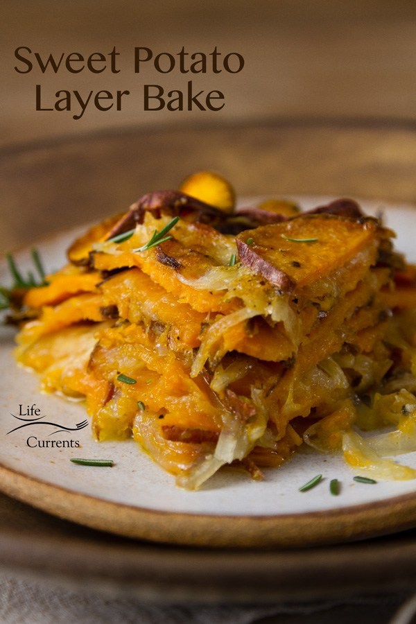 Cheesy layered sweet potato bake on plate.