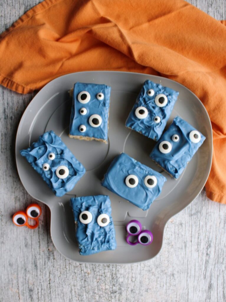 plate of blue monster rice krispie treats with eyeball rings,