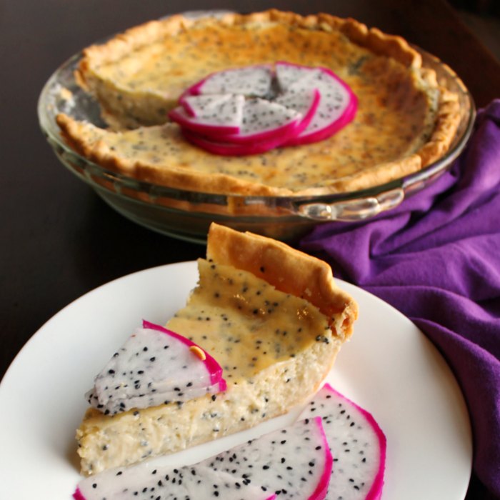 slice of creamy dragon fruit pie on plate with slices of fruit as garnish, remaining pie in background.