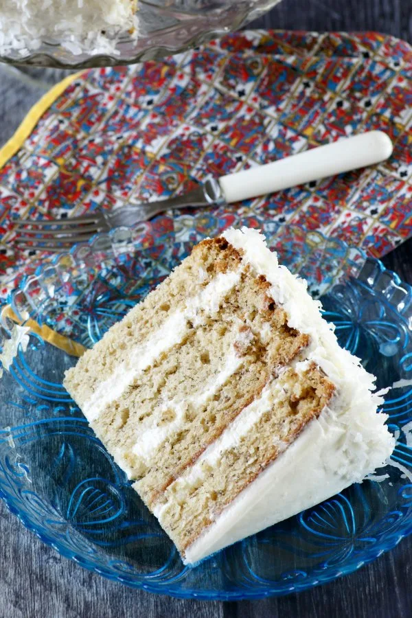 close up of slice of star spangled banana cake with colorful napkin and fork