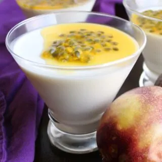 martini glasses filled with creamy white panna cotta and topped with yellow passion fruit.