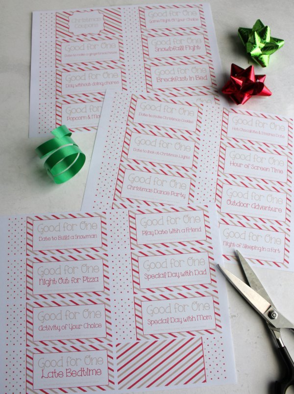 freshly printed pages of children's christmas coupon book ready to be cut and assembled.