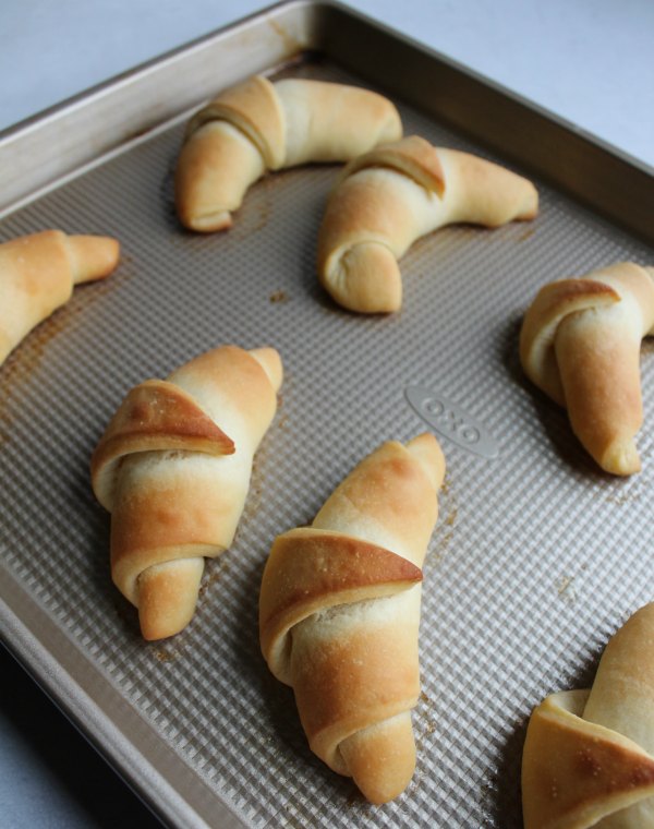 golden brown crescent rolls on baking sheet fresh from the oven