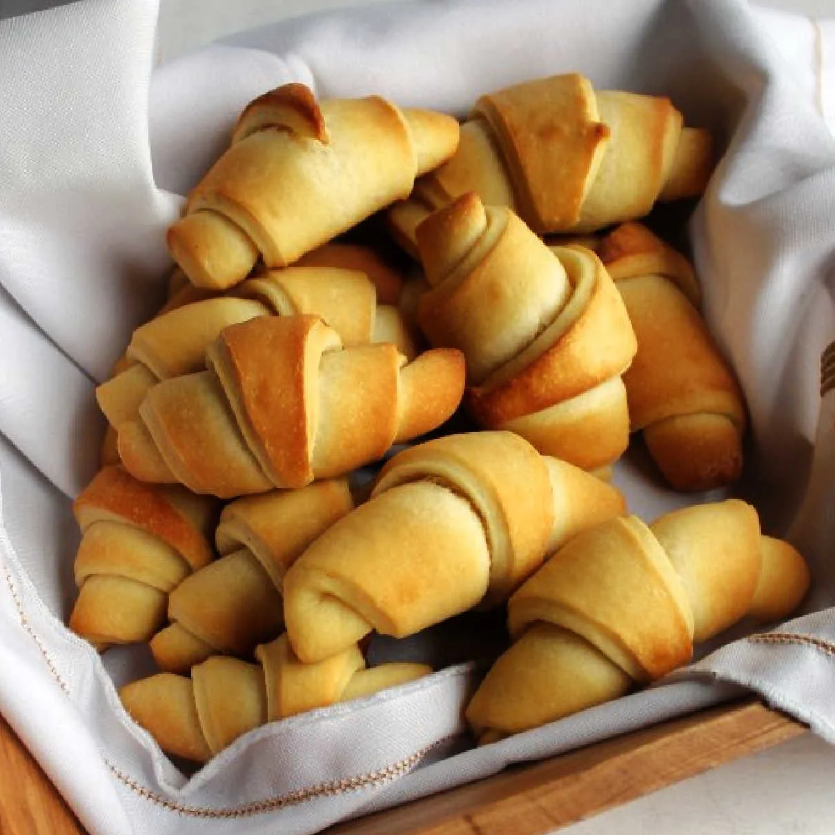 Close up of freshly baked golden brown crescent rolls.