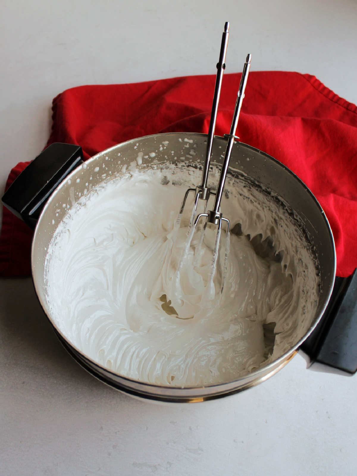 fluffy white seven minute frosting in double boiler.