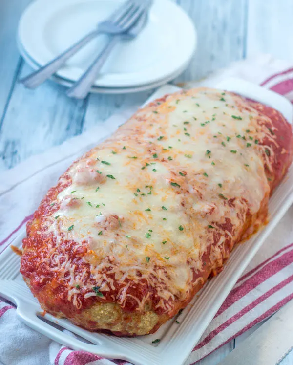 chicken parmesan meatloaf fresh from the oven with tomato sauce and melted cheese on top