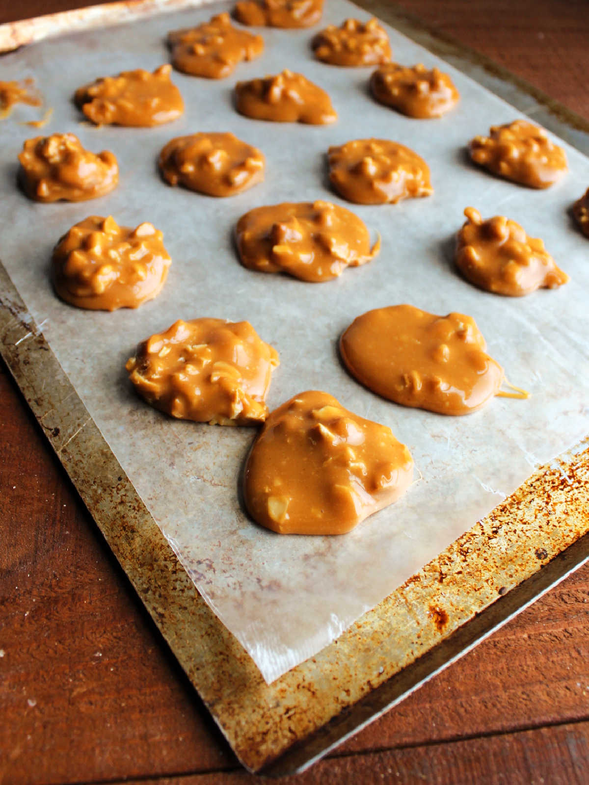 Caramel and cashew centers setting up on wax paper ready to be dipped in chocolate.