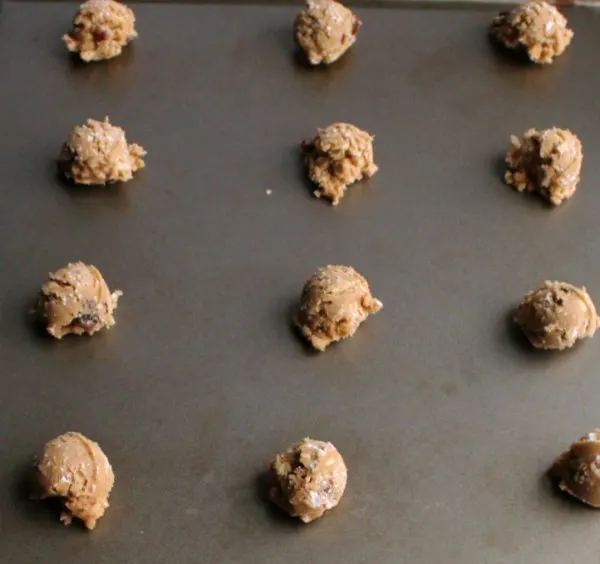 balls of oatmeal raisin cookie dough on baking sheet ready to go in oven.