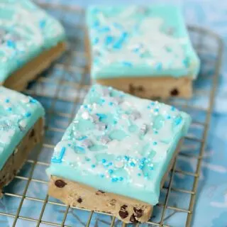 no bake peanut butter cookie dough bars with blue frosting and sprinkles.