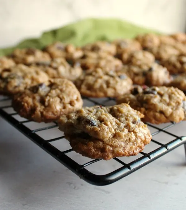 looking across a cooling rack filled with cranberry dark chocolate oatmeal cookies.
