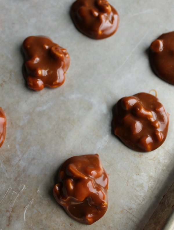 caramel and cashew mounds ready to be dipped in chocolate.