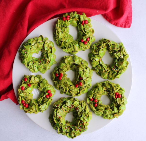 plate filled with no bake corn flake wreath cookies for Christmas.