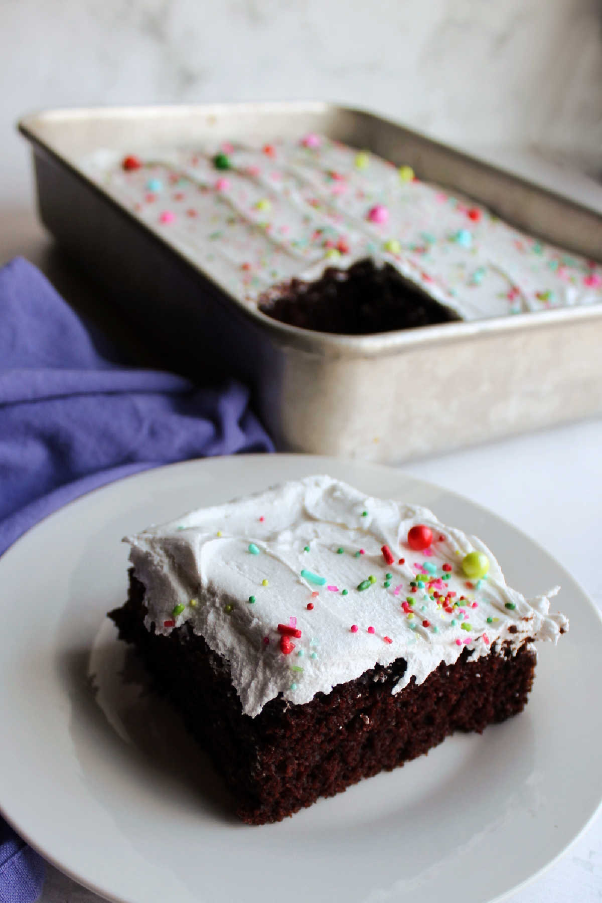piece of chocolate cake topped with 7 minute frosting.