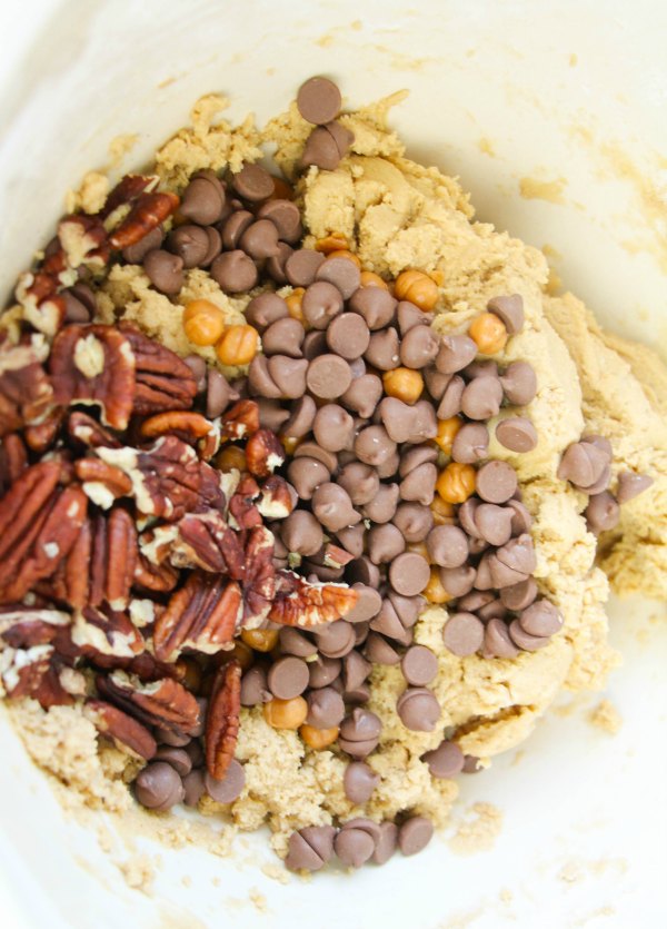 bowl of cookie dough with chocolate chips, caramel bits and pecans.