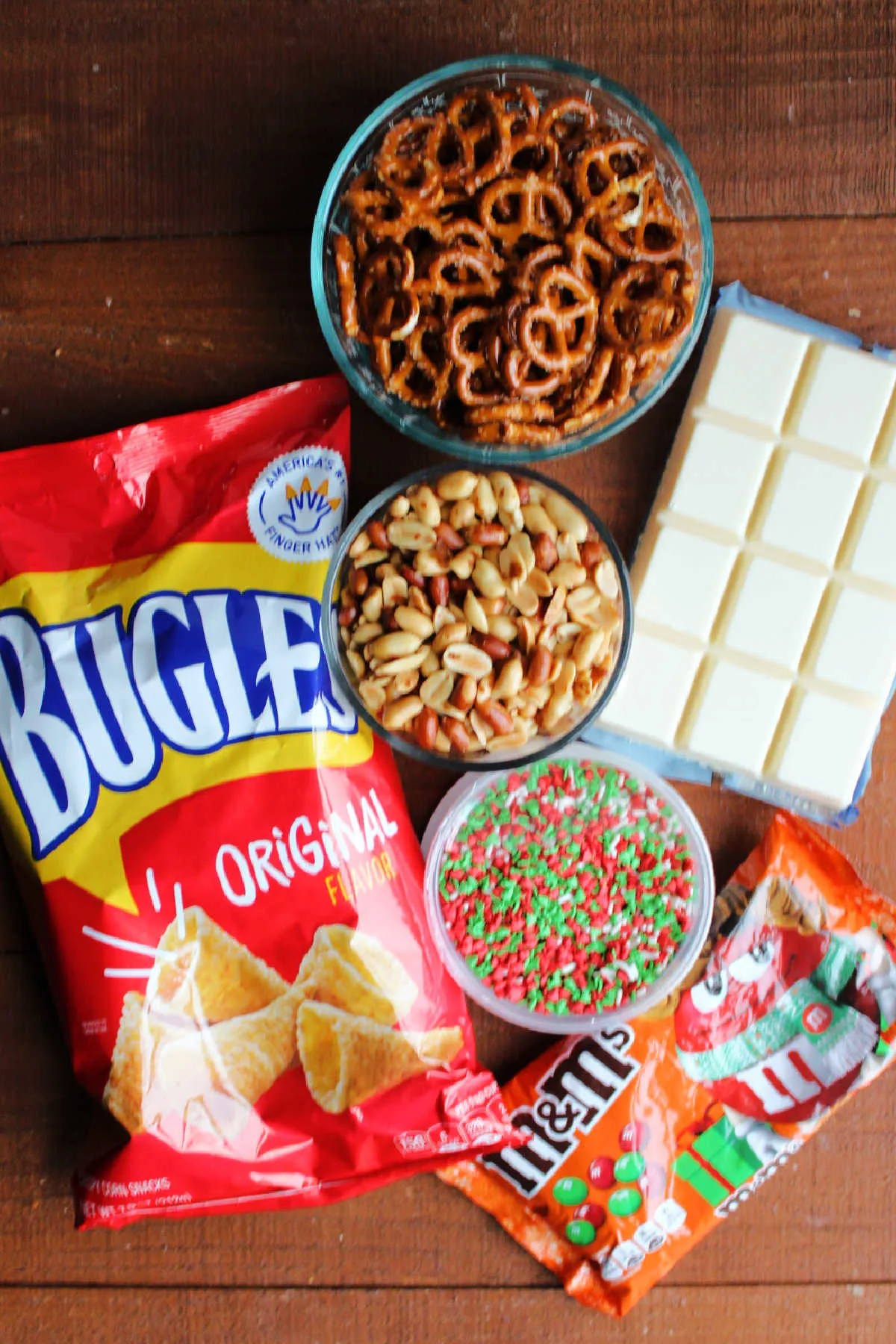 Ingredients: bugles, pretzels, peanuts, sprinkles, almond bark, sprinkles and m&ms ready to be made into snack mix.