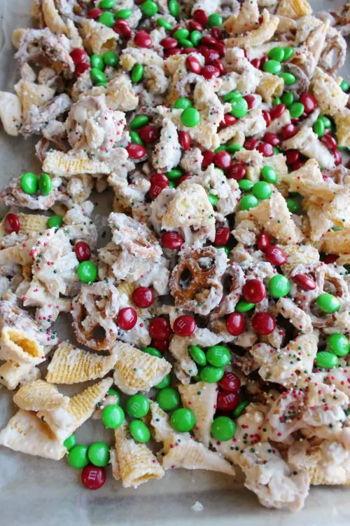 sweet and salty snack mix tossed in white chocolate with red and green candies .