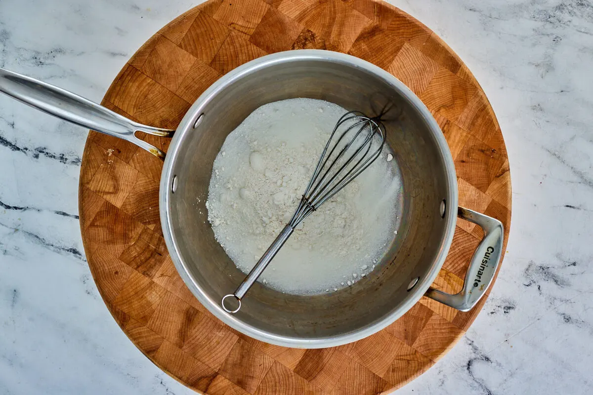 Sugar and flour whisked together in saucepan.