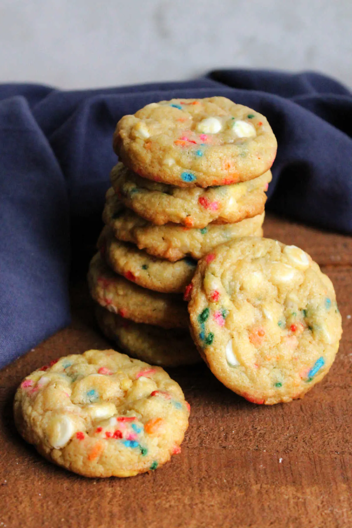 Stack of funfetti white chocolate chips cookies stacked on top of each other showing golden edges and soft sprinkle filled centers. 