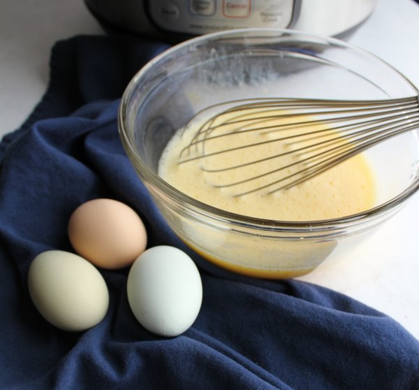 fresh eggs and lemon juice being whisked together to be added to soup.