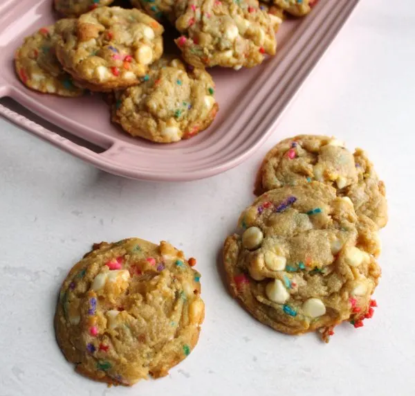 funfetti white chocolate chip cookies on pink platter.