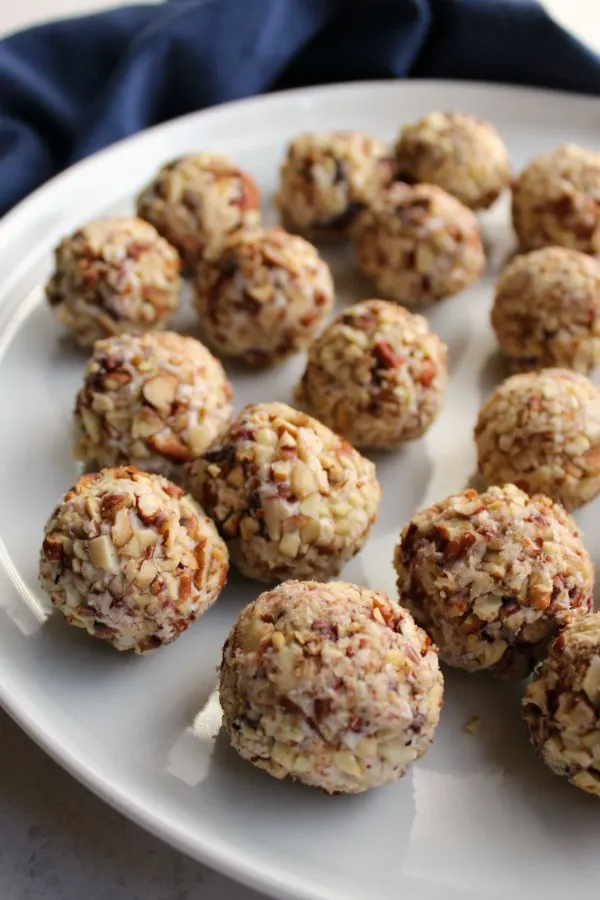 close up of plate filled with pecan coated cranberry blue cheese balls