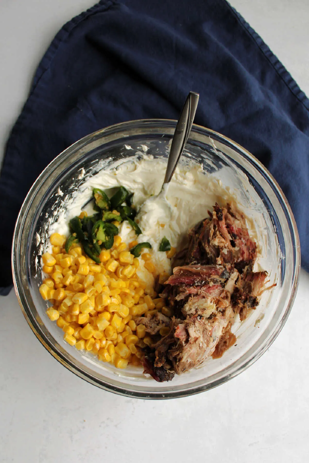 mixing bowl filled with creamy pulled pork dip ingredients.