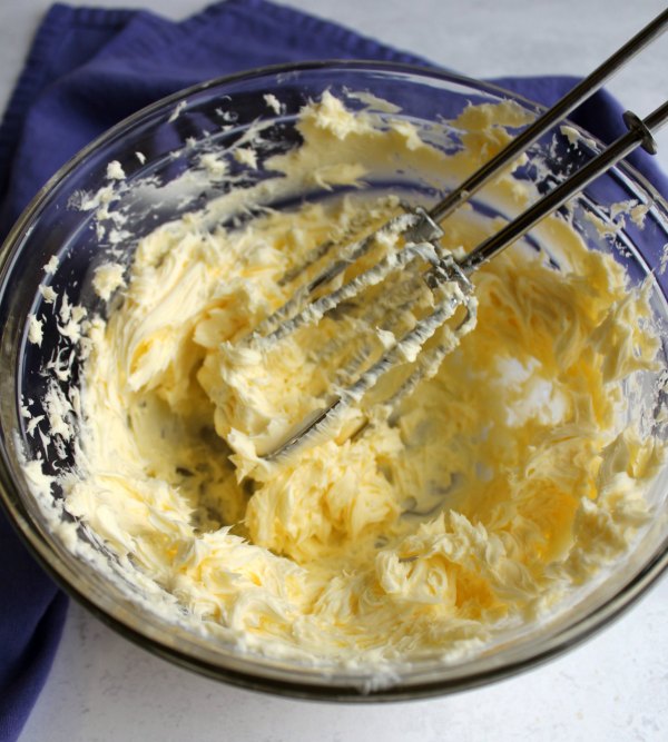 whipped butter in bowl ready for sweetened condensed milk to make Russian buttercream.