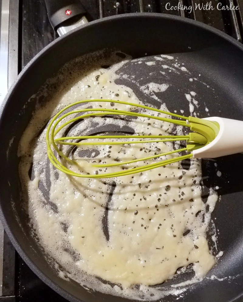 Making quick butter and flour roux in skillet with whisk.