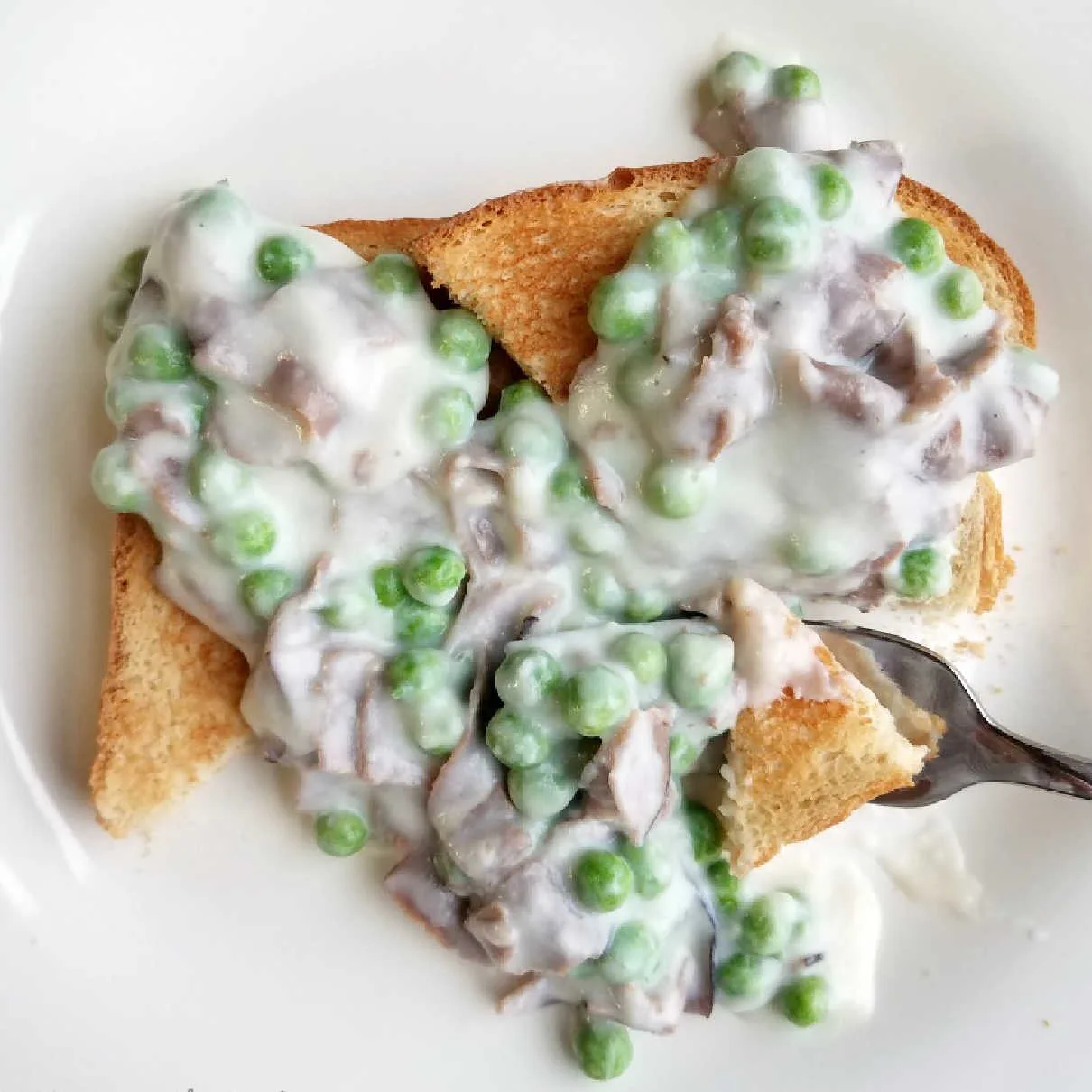 toast covered with creamed chipped beef and peas.