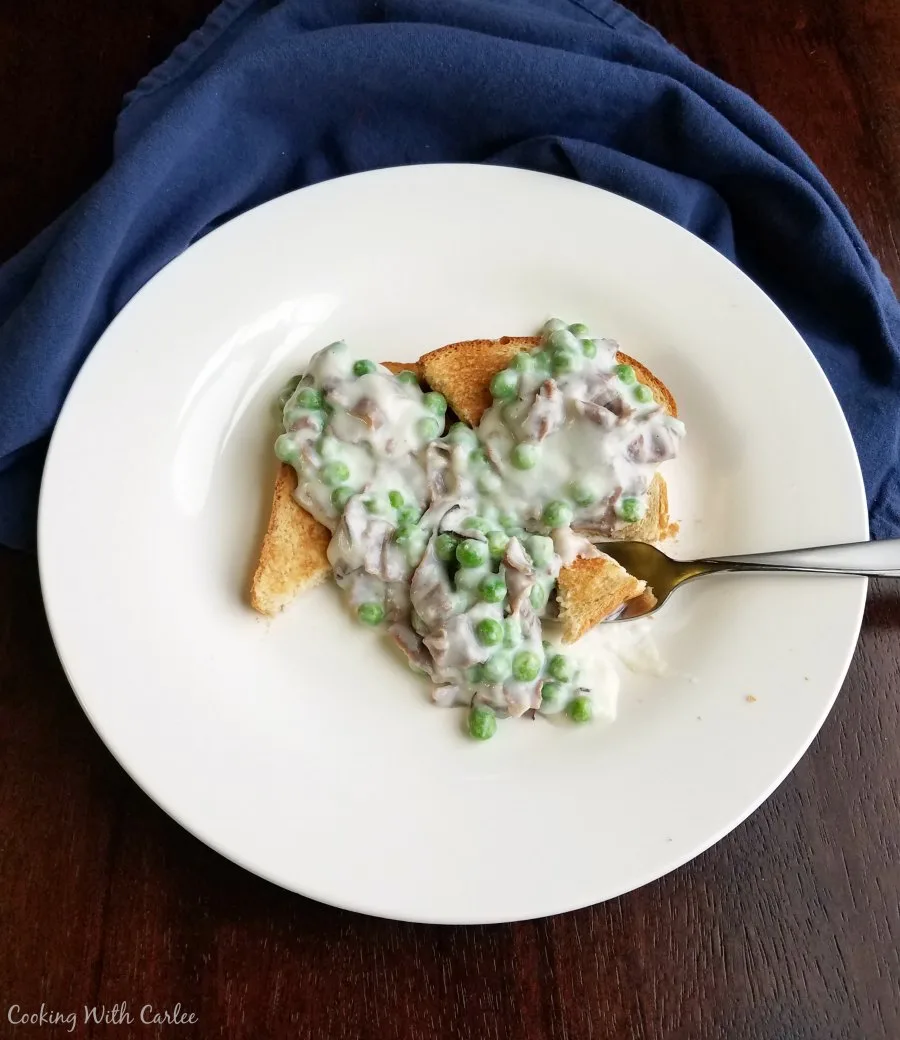 creamed chipped beef with peas served over toast. 