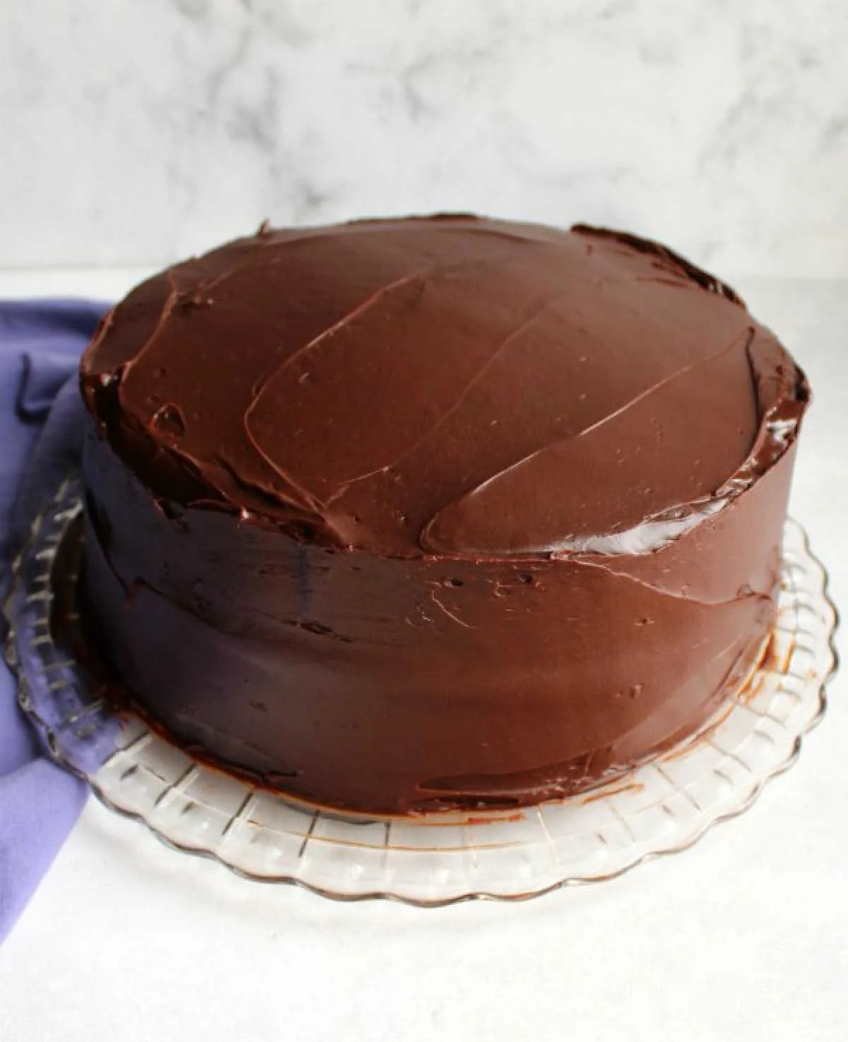 cake frosted with smooth glossy chocolate frosting.