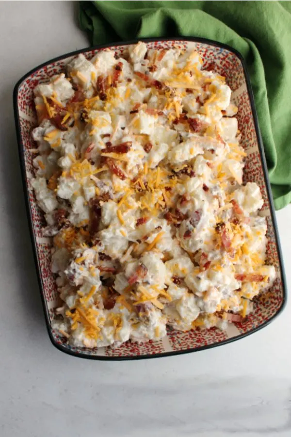 serving dish filled with cheddar bacon ranch potato salad ready to eat
