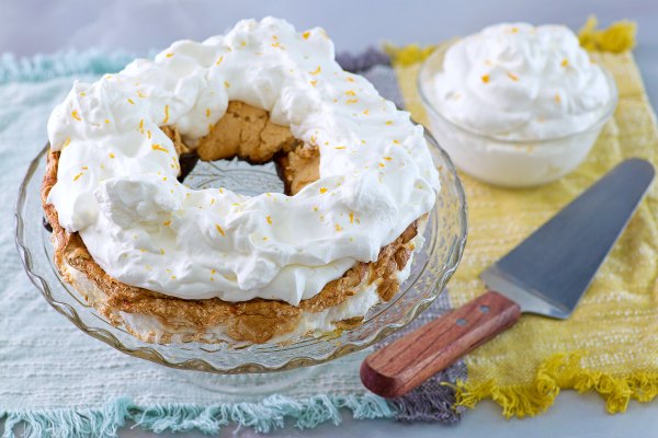forgotten meringue torte with whipped cream and orange zest on top