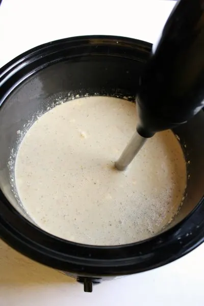 using an immersion blender to make a smooth soup in crock pot.