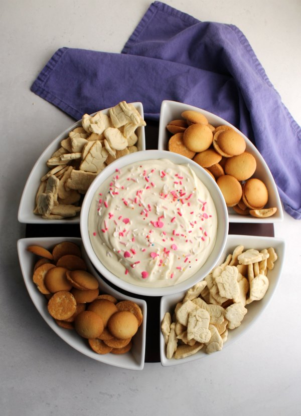 serving dish with animal crackers, nilla wafers and sprinkle topped lemon dip