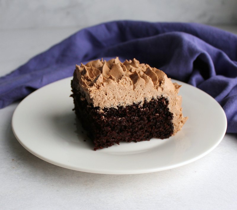 slice of chocolate sheet cake with fluffy chocolate buttercream on top