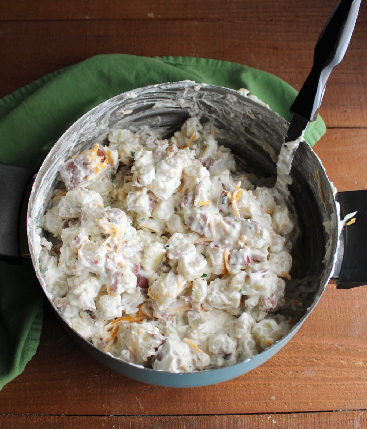 Large pot filled with freshly made bacon ranch potato salad, ready to chill.