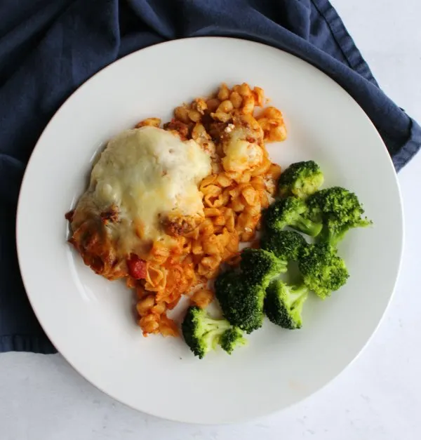 Dinner plate filled with no boil pasta casserole and broccoli ready to eat.