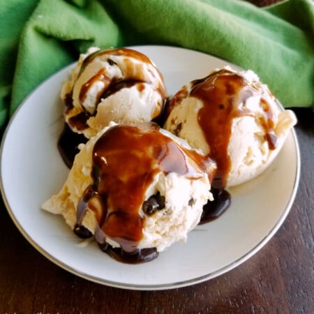 Easy Homemade Hot Fudge Sauce 2 Bowl of peanut butter chocolate chip no churn ice cream topped drizzled with homemade hot fudge sauce.