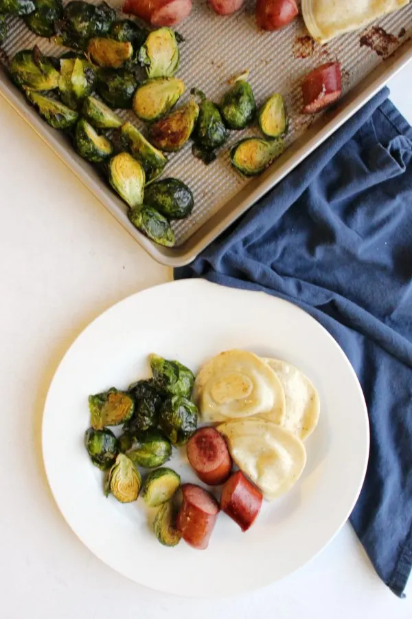It is hard to think of a dinner easier than this one. Cook kielbasa, pierogies and brussels sprouts all on one sheet pan for a tasty and super simple supper.
