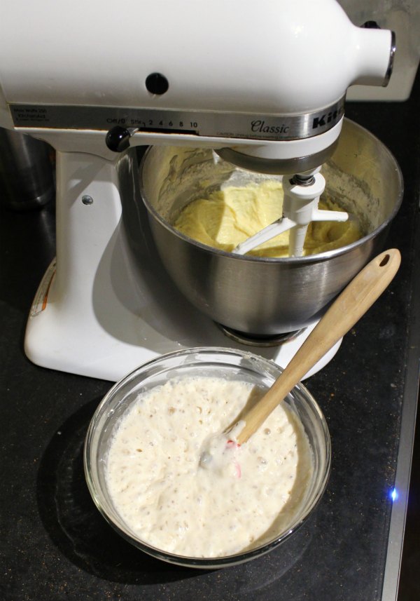 mixer beating butter next to bowl of bubbly sponge ready to be mixed in.
